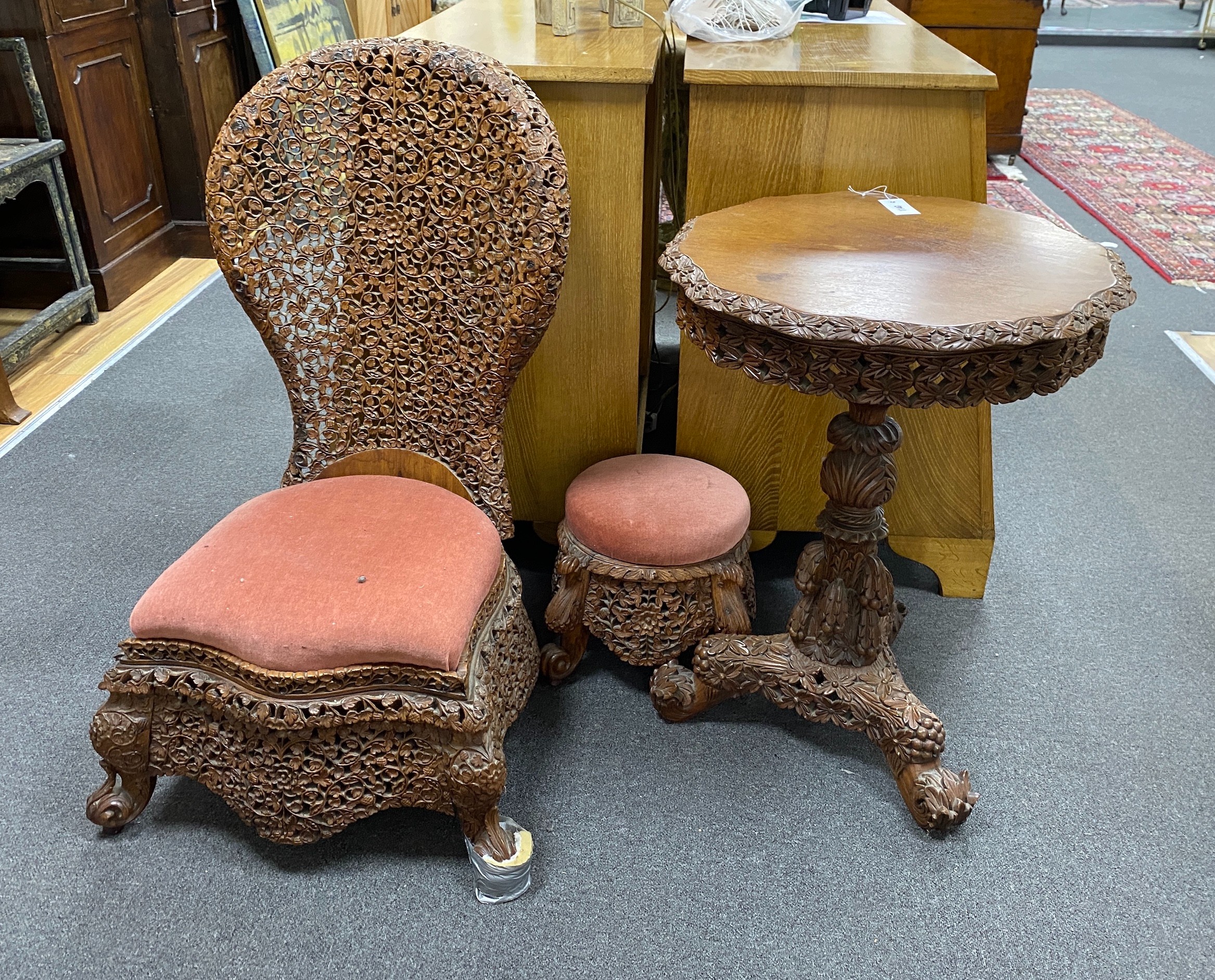 A Burmese carved hardwood circular occasional or centre table, diameter 57cm height 74cm, together with a similar side chair and foot stool